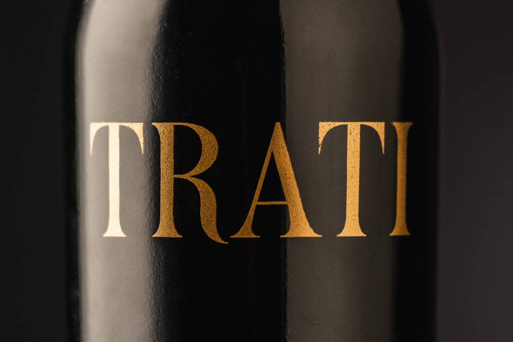 Trati wine bottle and label design by Nano Alfonsin Studio. Limited-edition red wine, Sangiovese & Merlot blend, with gold typography and artisanal details.
